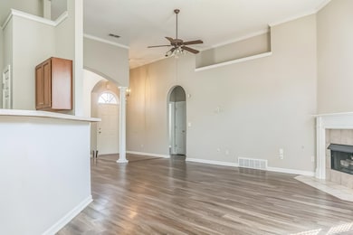 Unfurnished living room featuring a tiled fireplac
