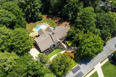 View from above of property featuring a pool area and a forest