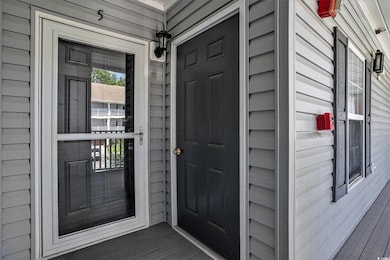 View of exterior entry with a porch