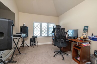 Office featuring lofted ceiling and carpet floors