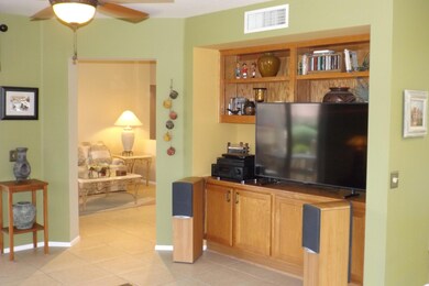 FAMILY ROOM HAS BUILT IN MEDIA CABINETRY AND CEILING FAN.