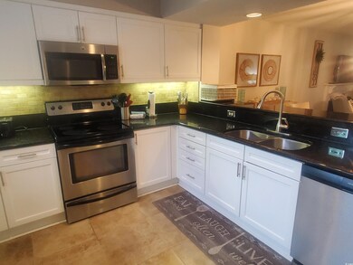 Kitchen featuring stainless steel appliances, a si