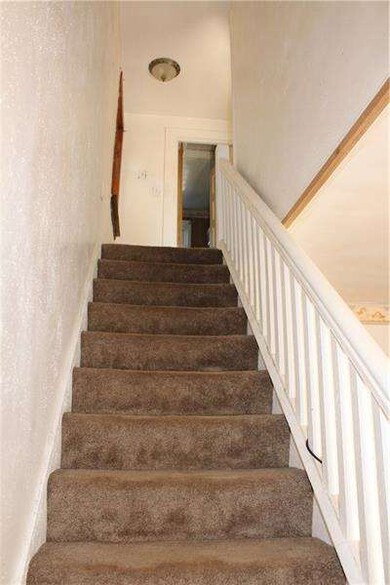 neutral carpeting continues up the stairwell
