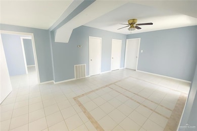 Unfurnished room featuring light tile patterned floors and ceiling fan
