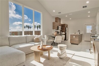 Living room featuring sink and vaulted ceiling