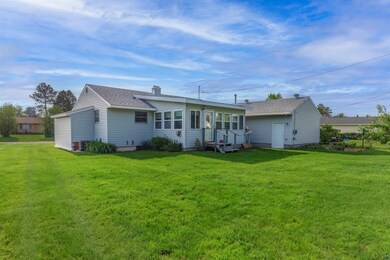 Rear view of house featuring a lawn