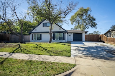 View of front of property with driveway and a garage
