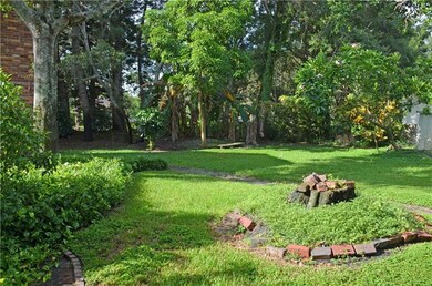 Back yard behind the main house, shows the woodsy 