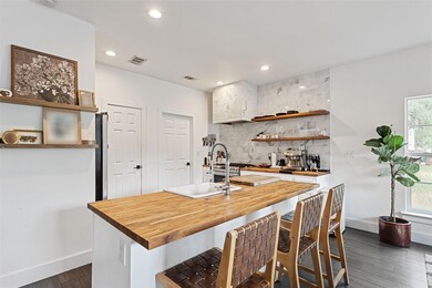Kitchen with decorative backsplash, dark wood-sty