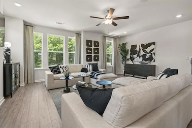 Living room featuring wood finished floors, recessed lighting, and ceiling fan