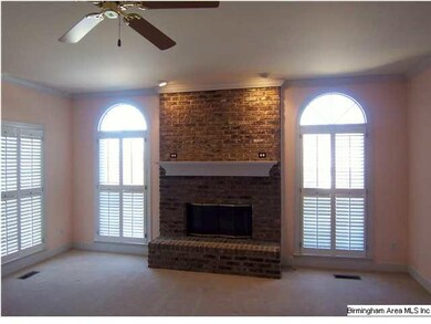 Large living room features elegant fireplace and l