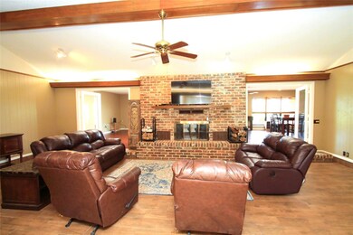Living room with vaulted ceiling, hardwood / wood-