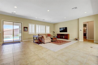 Living room features tile flooring, vaulted ceilin