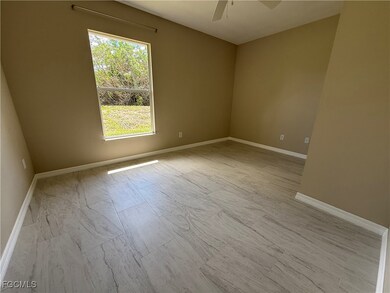 Spare room with baseboards and a ceiling fan