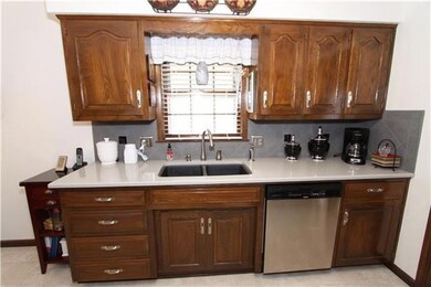 Quartz countertop, slate backsplash, black sink, high rise spray faucet...