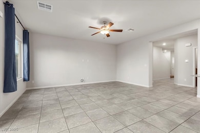 Unfurnished room featuring ceiling fan and light tile patterned floors