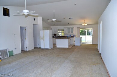 Unfurnished living room featuring ceiling fan, lig