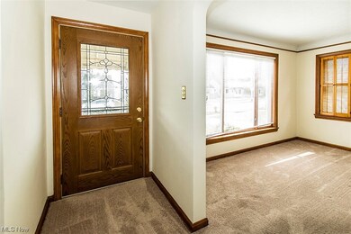 Foyer featuring a healthy amount of sunlight and light colored carpet