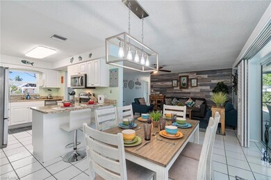 Dining room with wooden walls, plenty of natural light, an accent wall, light tile patterned floors, and a textured ceiling