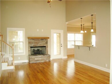 The two story great room has a stone fireplace wit