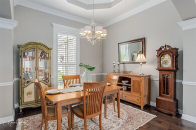 Dining space with ornamental molding, a raised cei