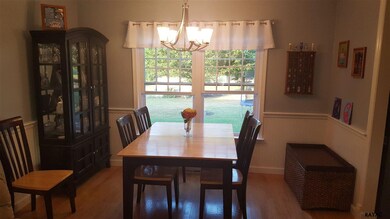 Separate dining room with hardwood floors overlook