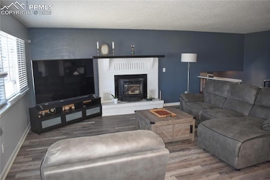 Living area with baseboards, visible vents, wood f