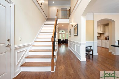 Two story foyer entry way with wood flooring and j