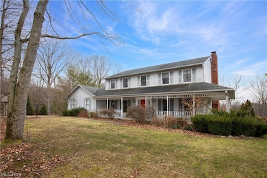View of front facade with covered porch and a front yard