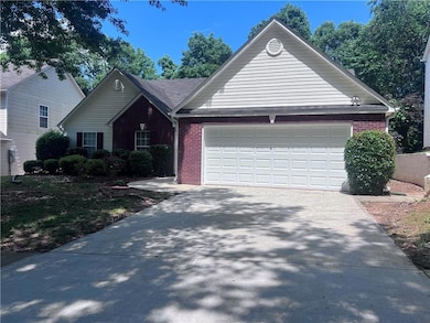 View of front facade with a garage, brick siding, 