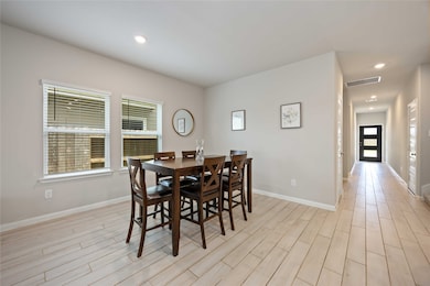 The dining area feels airy and open, with large wi