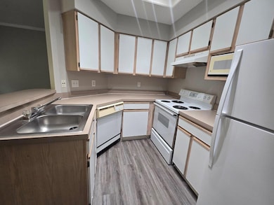 Kitchen featuring white appliances, under cabinet