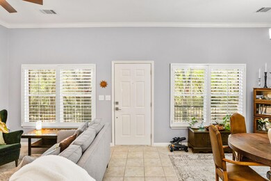 Entrance foyer featuring ceiling fan, ornamental 