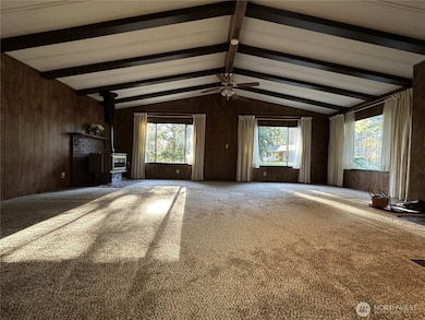The living room is very large with lots of natural light.