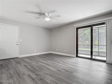 Empty room featuring baseboards, a ceiling fan, an