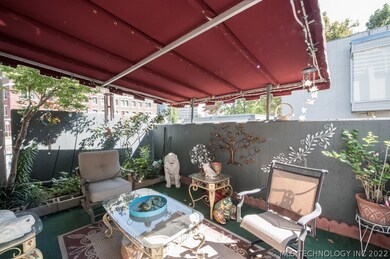 Wonderful covered front patio with a section of pr