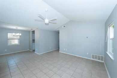 Empty room featuring a chandelier, lofted ceiling