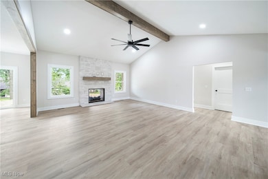 Unfurnished living room featuring a ceiling fan, a fireplace, light wood finished floors, and recessed lighting