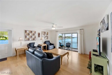 Living room with light wood-style floors and ceiling fan