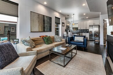Living area featuring recessed lighting and dark wood-style flooring