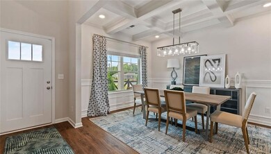 Dining room with beamed ceiling, crown molding, co