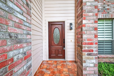Covered front entry features updated tile flooring