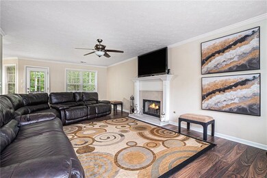 Living room with wood finished floors, a ceiling f
