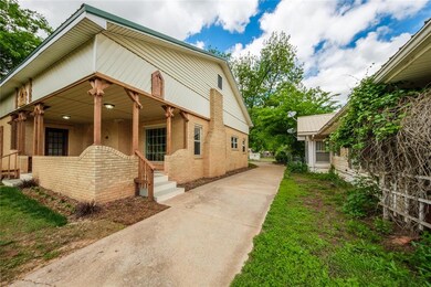 View of front of home featuring brick siding, a po