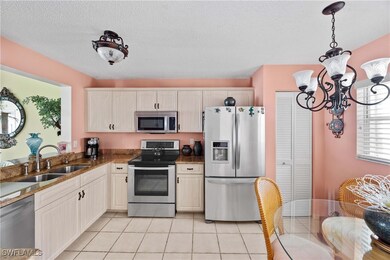 Kitchen with pendant lighting, sink, appliances wi