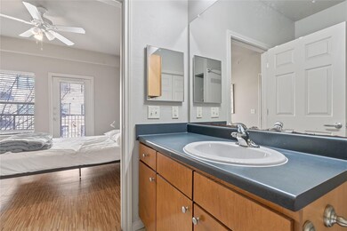 Ensuite bathroom with vanity, ceiling fan, and wo