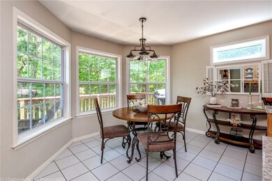 Eat-in-kitchen with bay windows overlooking the back patio.