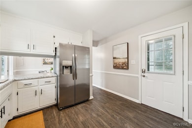 Kitchen with stainless steel refrigerator with ice