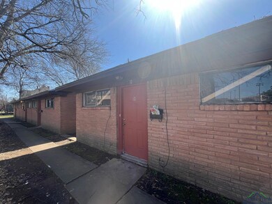 Doorway to property featuring brick siding