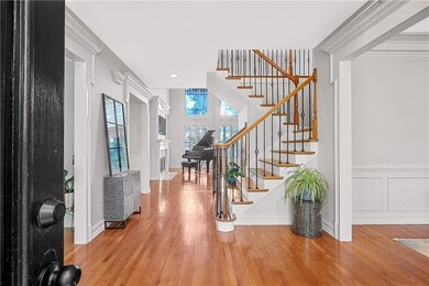 Empty room with ornamental molding and light wood finished floors
